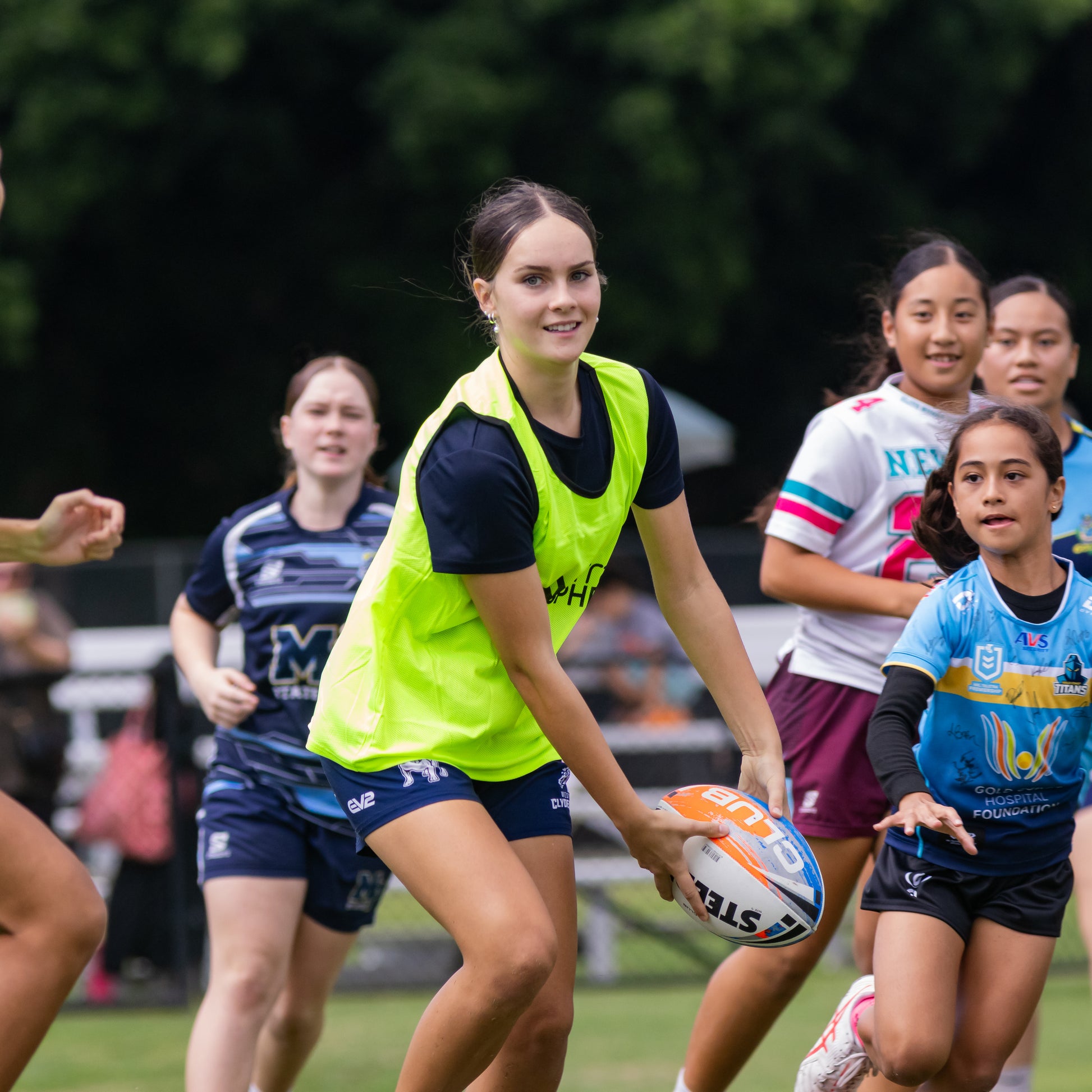 Young female rugby league player passing in skills drill game