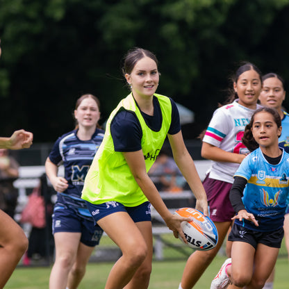 Young female rugby league player passing in skills drill game