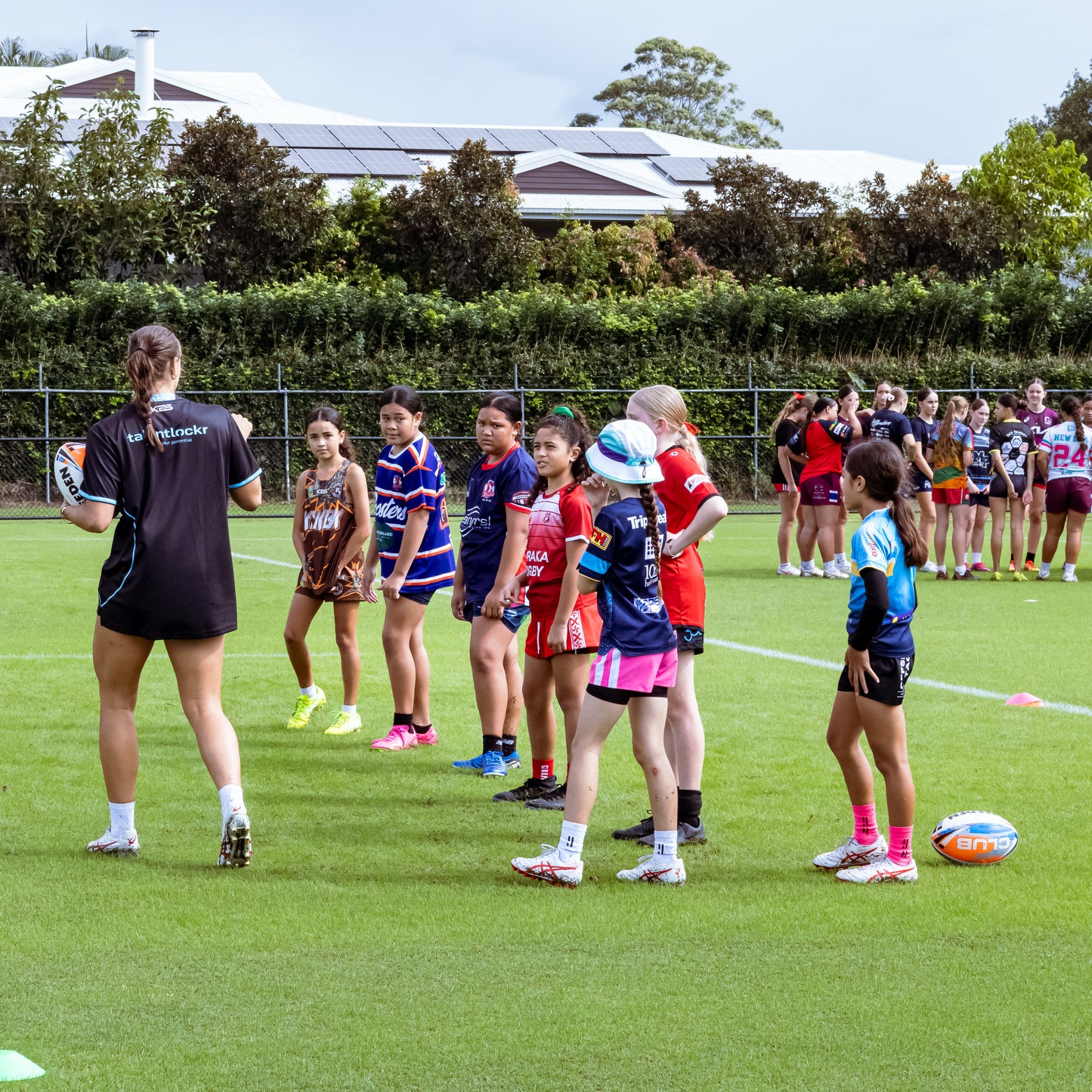 Georgia Grey instructing young female rugby league players in skills drill