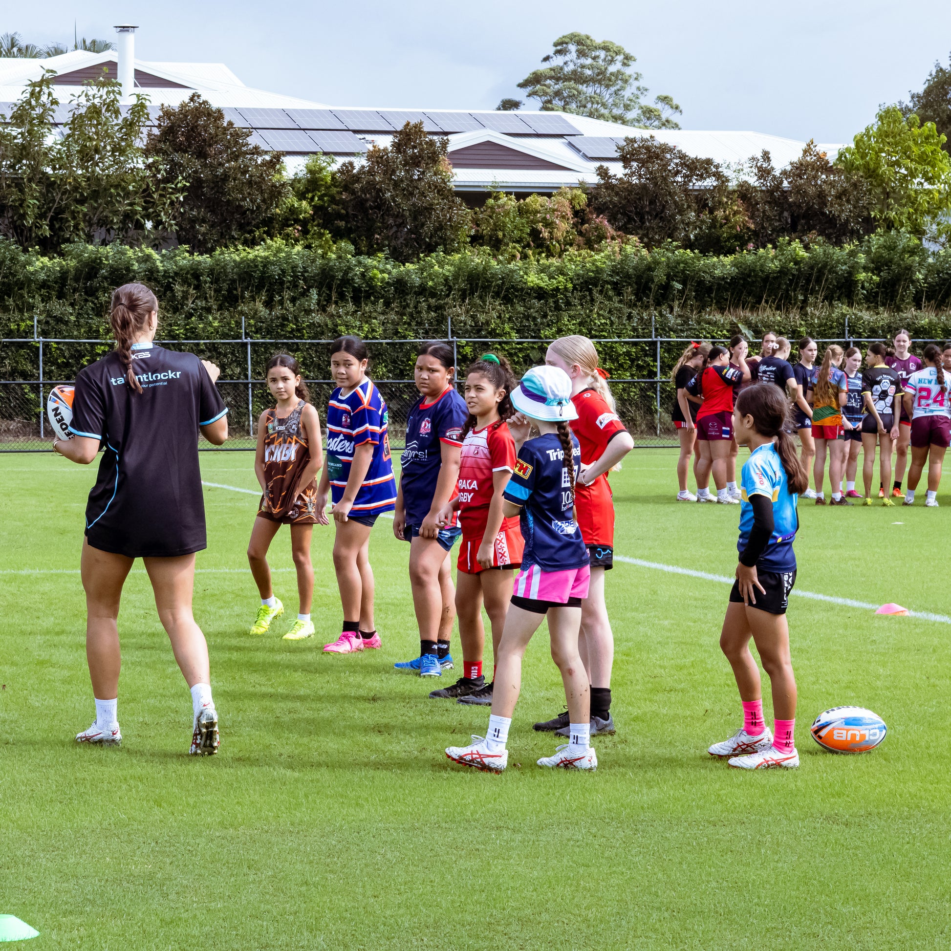 Georgia Grey instructing young female rugby league players in skills drill