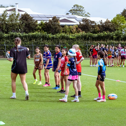 Georgia Grey instructing young female rugby league players in skills drill